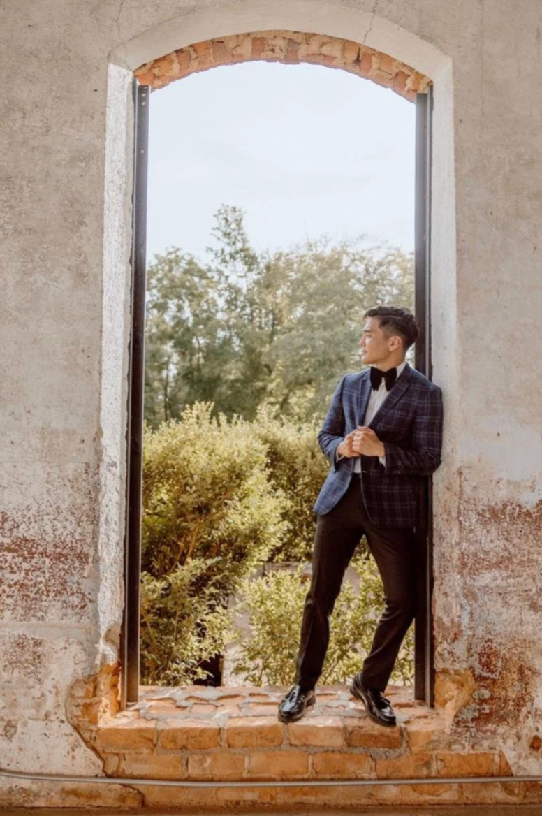 Tim Guercio standing in an arched window